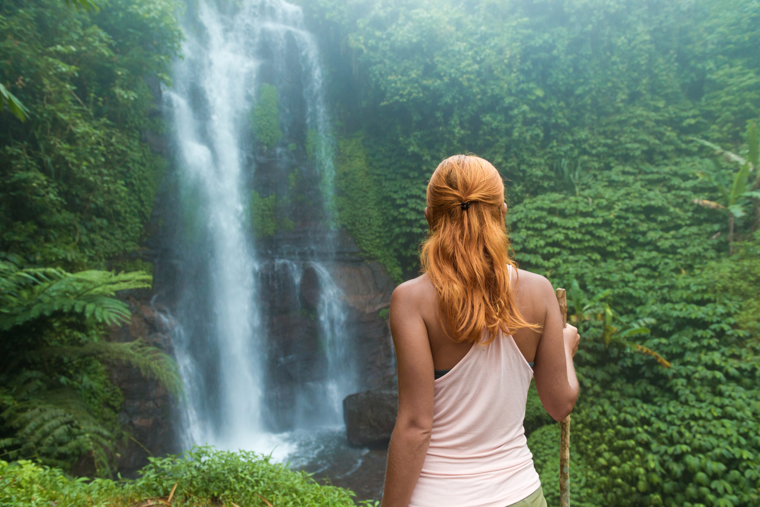 Female adventurer looking at waterfall